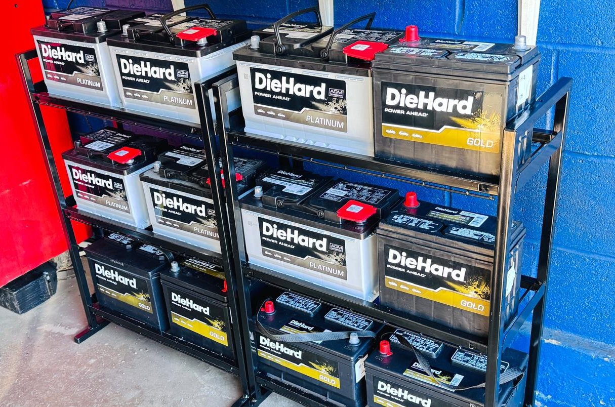 DieHard Gold and Platinum AGM batteries on the rack at Frontline Auto Plus